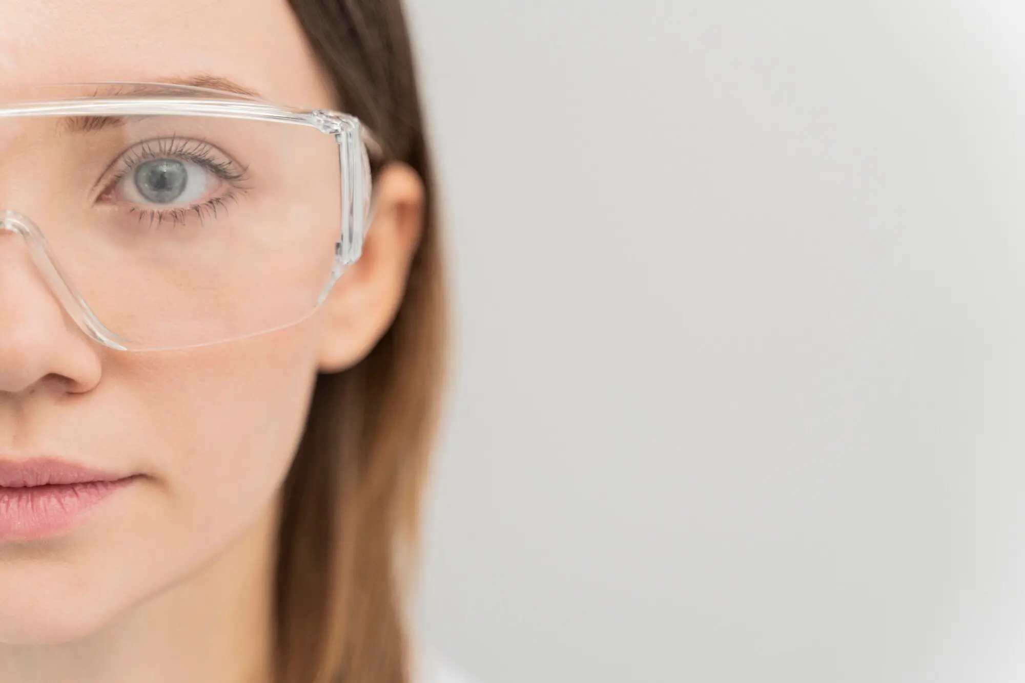 Professional wearing safety glasses in laboratory setting